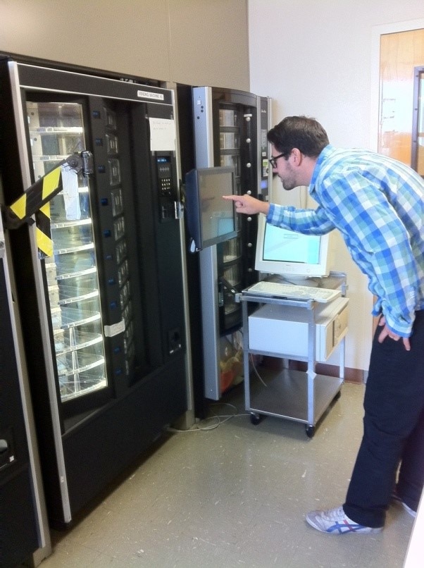 A person selects food from a vending machine.