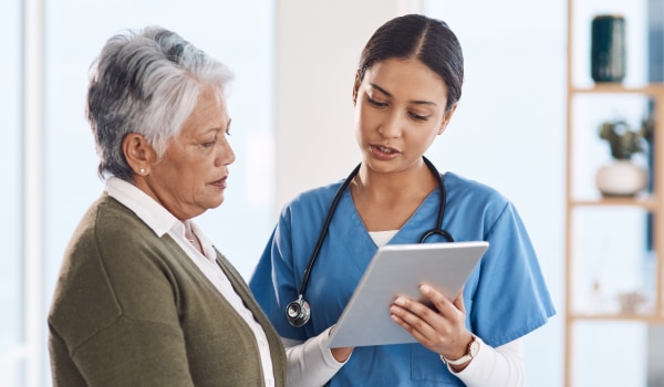 A health care professional speaking to a patient. 