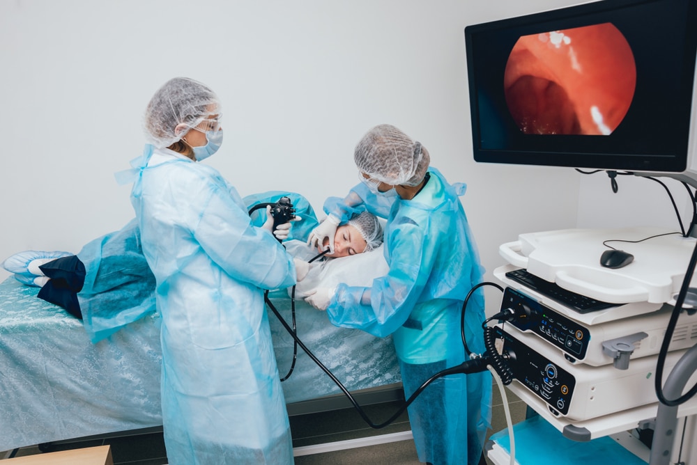 Health care professionals performing an upper GI endoscopy.