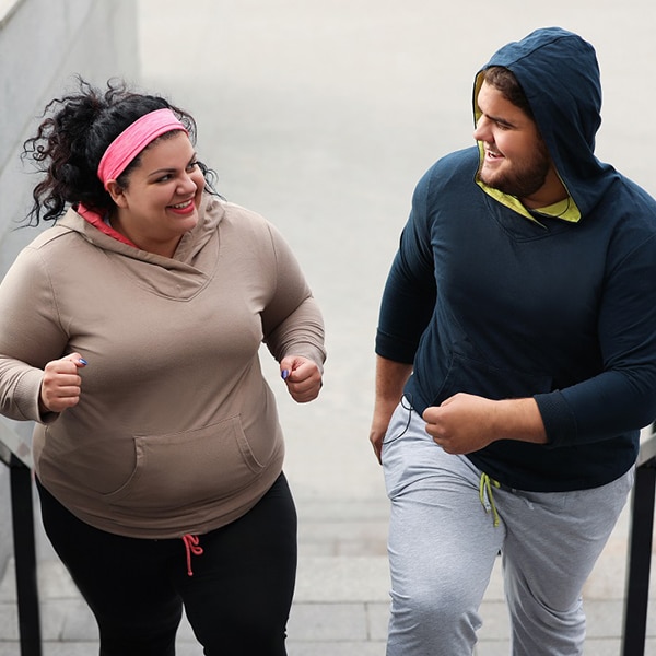 https://www.niddk.nih.gov/-/media/Images/Health-Information/Featured-Images/Overweight_Couple_Running_Stairs.jpg?h=600&iar=0&w=600&hash=7B7C145BF978C90E1C195DB933BD876E