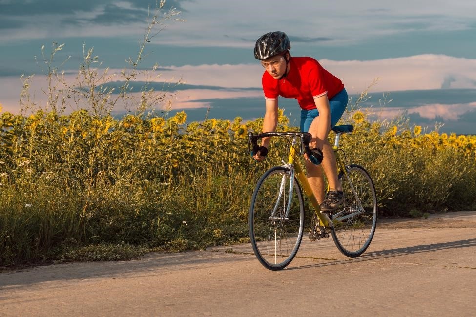 Man standing up while pedaling a bicycle