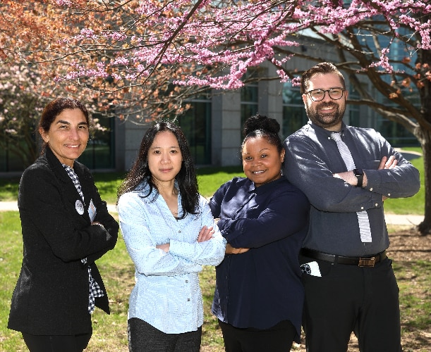 Lorraine Moore, Christine Krieger, Sandy Redman-Gomez, and Angel de la Cruz standing outside and smiling.