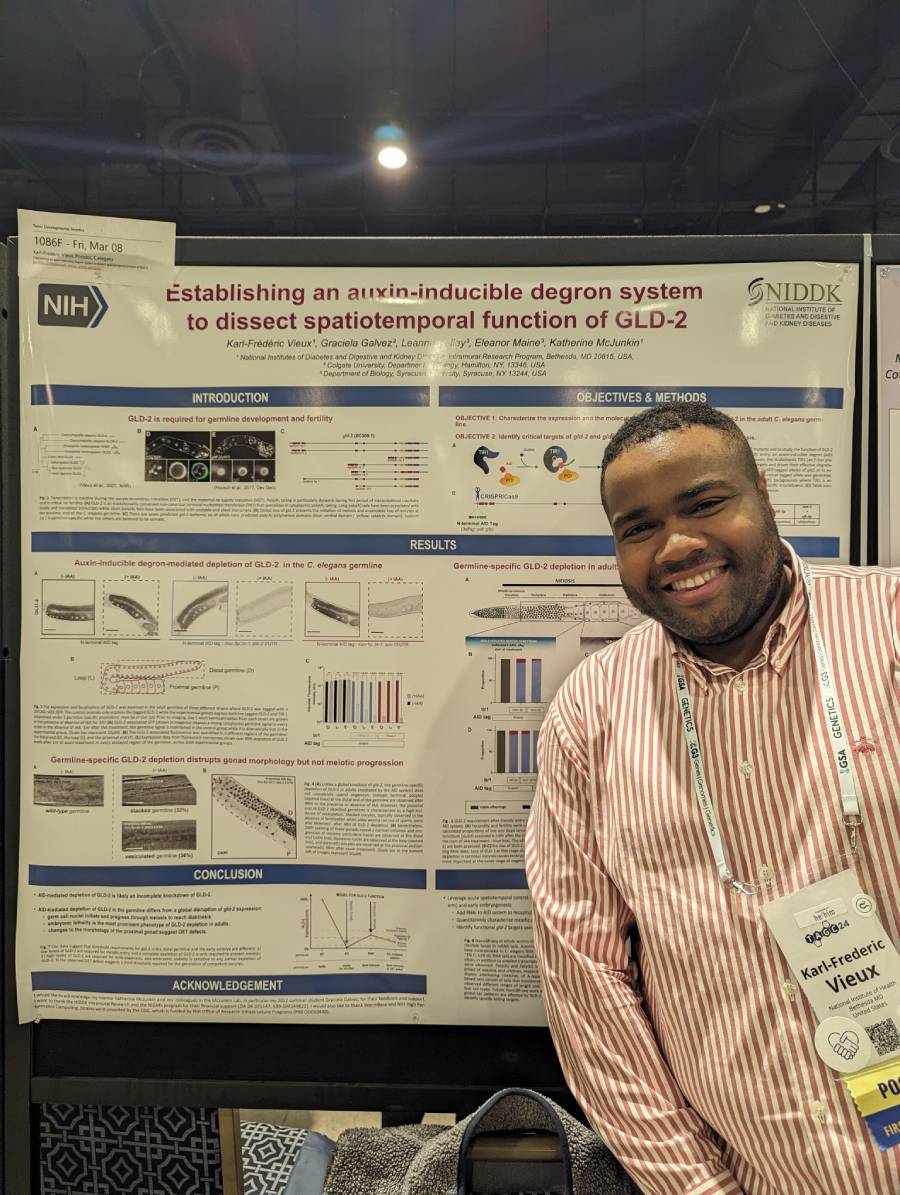 NIDDK Section on Regulatory RNAs lab member posing in front of a poster at the Allied Genetic Conference.