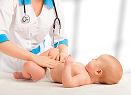 doctor inspecting a newborn baby